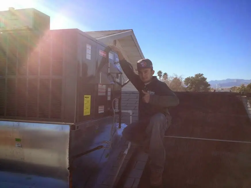 HVAC technician performing HVAC Inspection on a rooftop unit in Mahtomedi